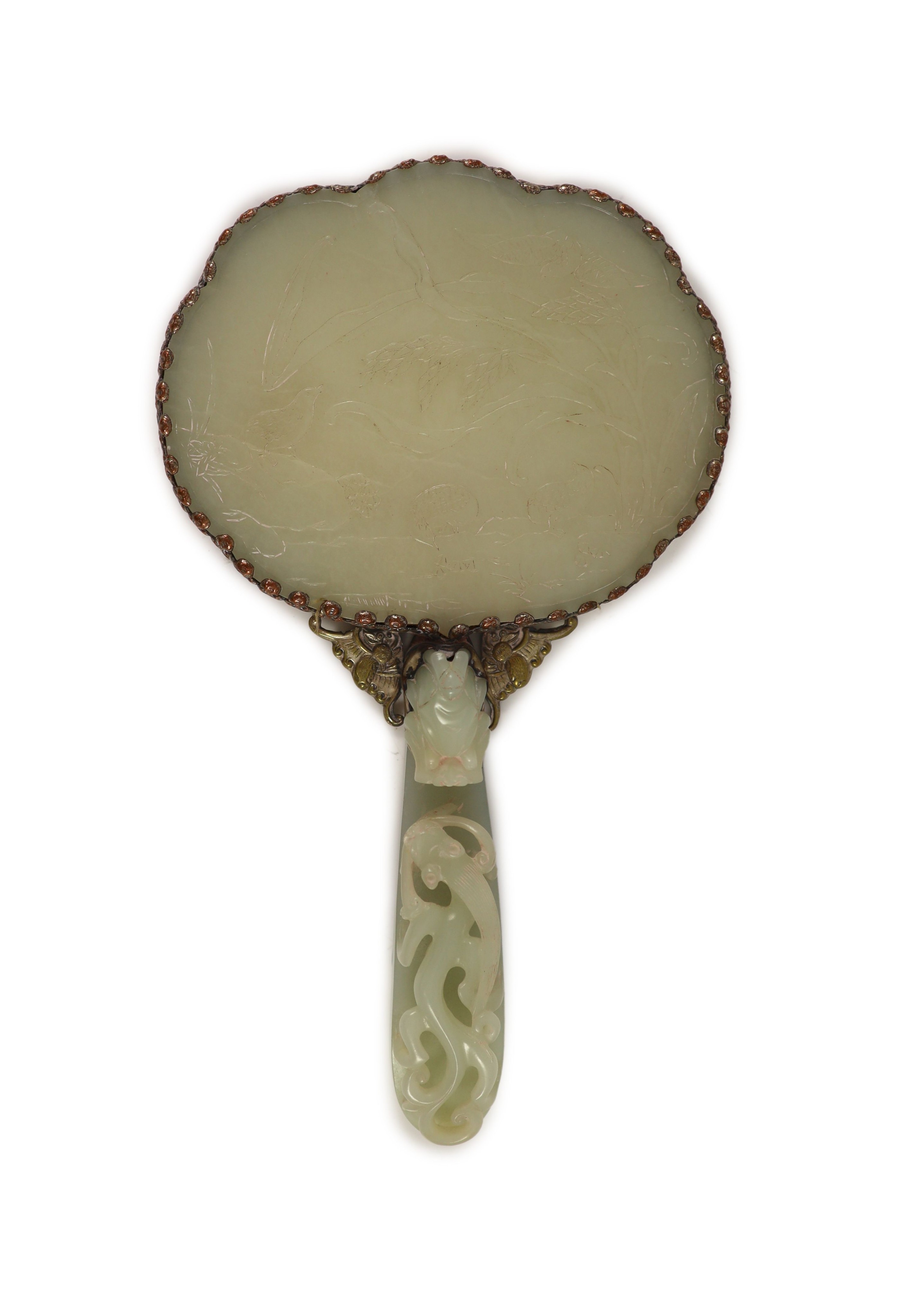 A Chinese pale celadon jade mounted hand mirror, the jade 18th/19th century, 24.2cm long, plaque 13.2 x 11.5cm, belt hook handle 12.3cm